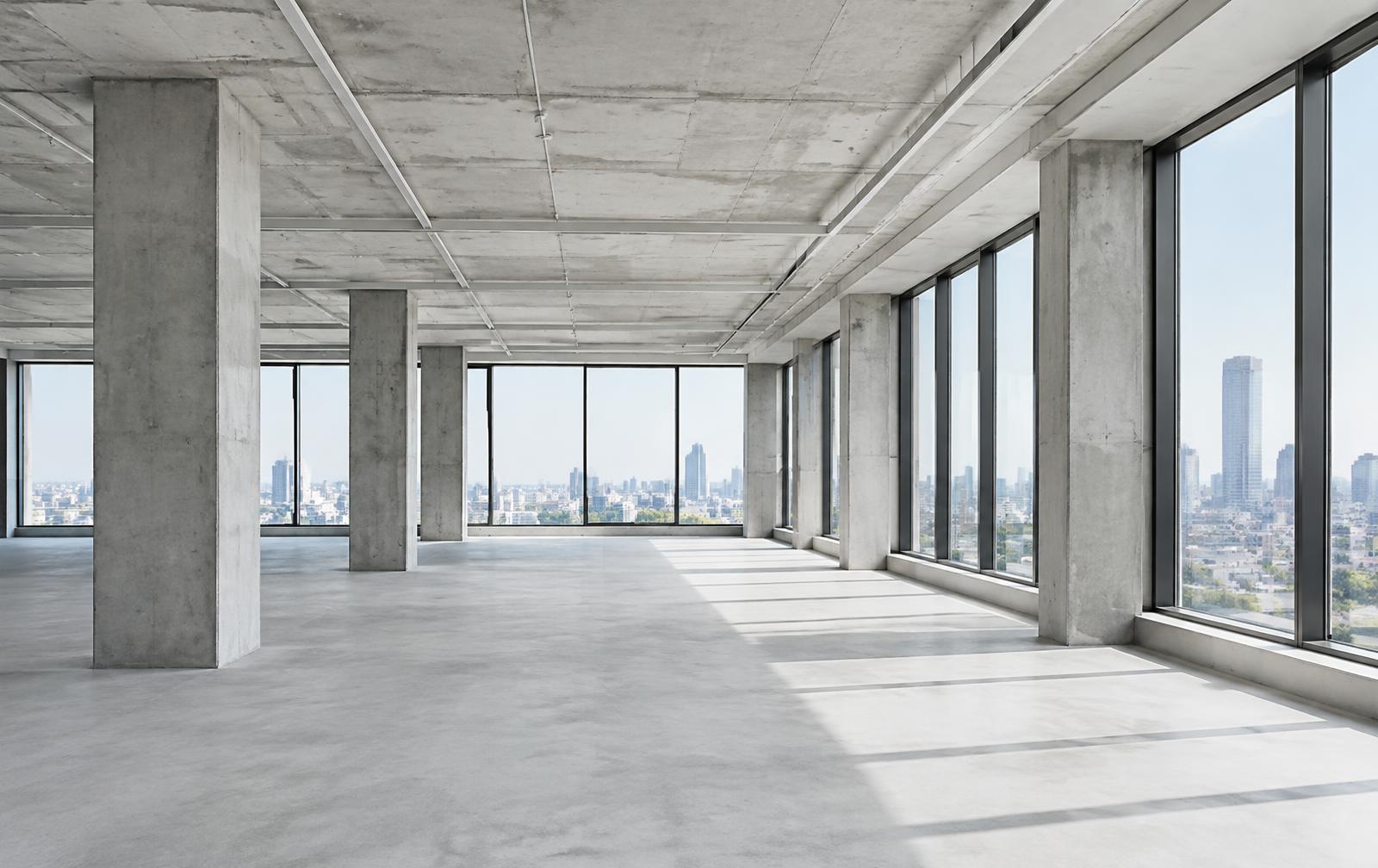 Open commercial floor with concrete columns and large windows